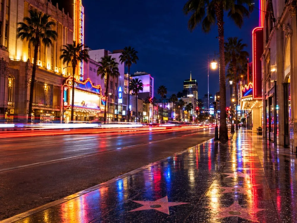 The boulevard at night with neon and traffic trails